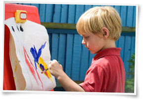 Child painting on easel